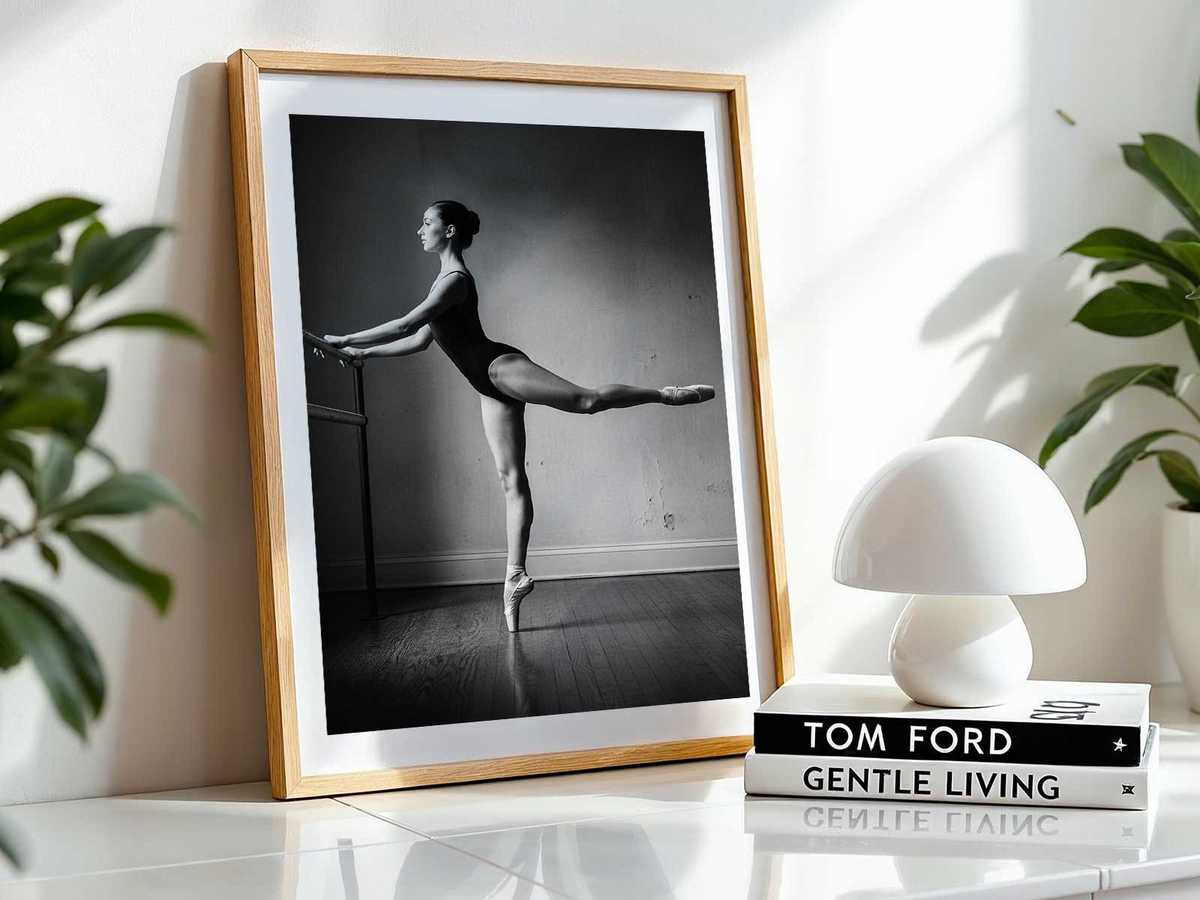 Close view of a dancer’s foot resting on the barre while the body balances, showing tension and elegance in practice