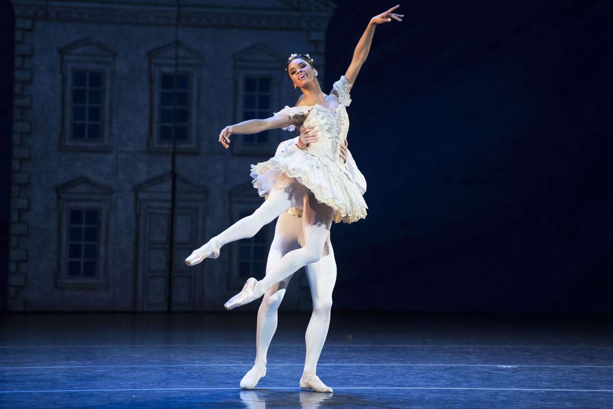 Misty Copeland launching into a powerful leap, muscles engaged and form perfectly aligned