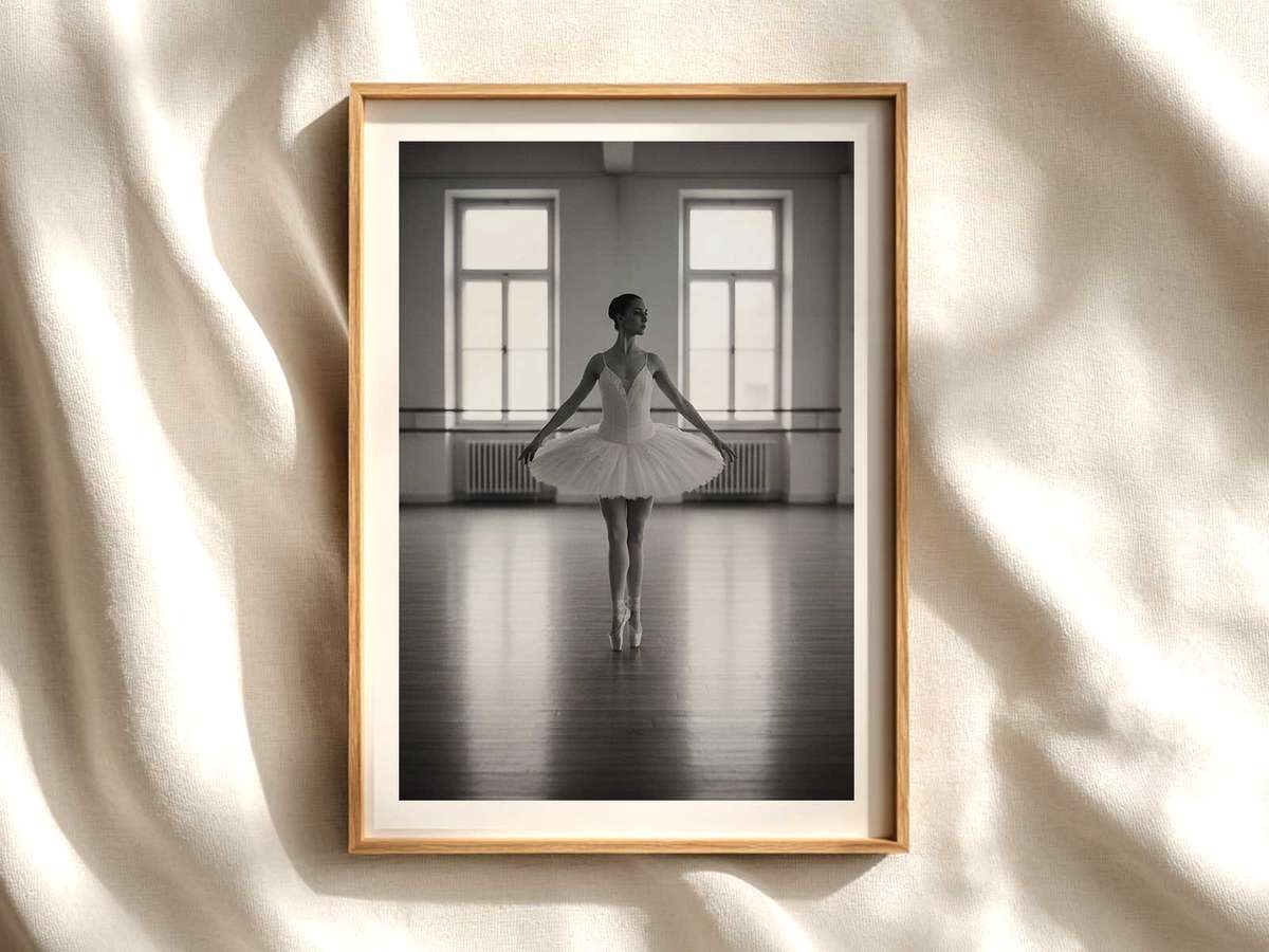 Ballerina standing in a dim rehearsal studio, eyes lowered and arms held in a measured pose conveying quiet concentration