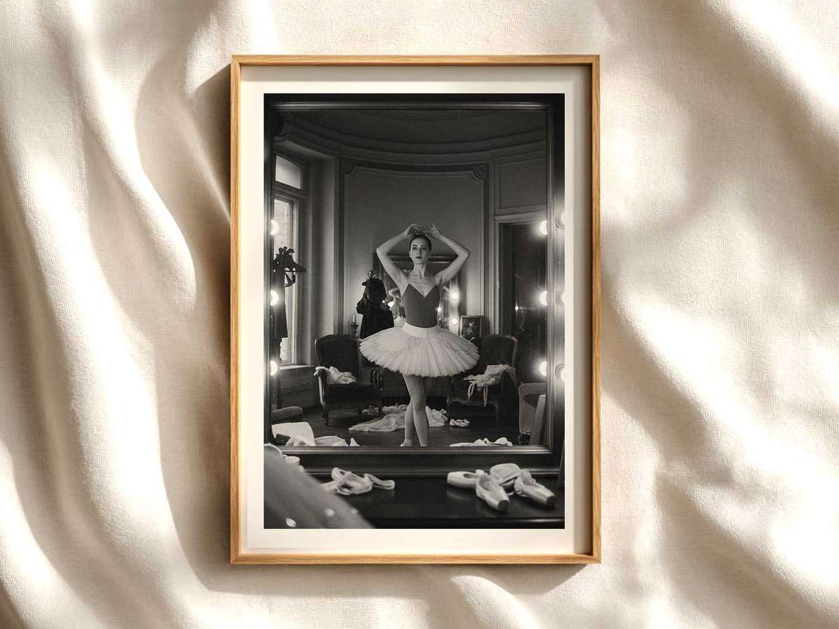 Ballerina performing a plié facing a studio mirror, her reflection aligning to create a doubled line