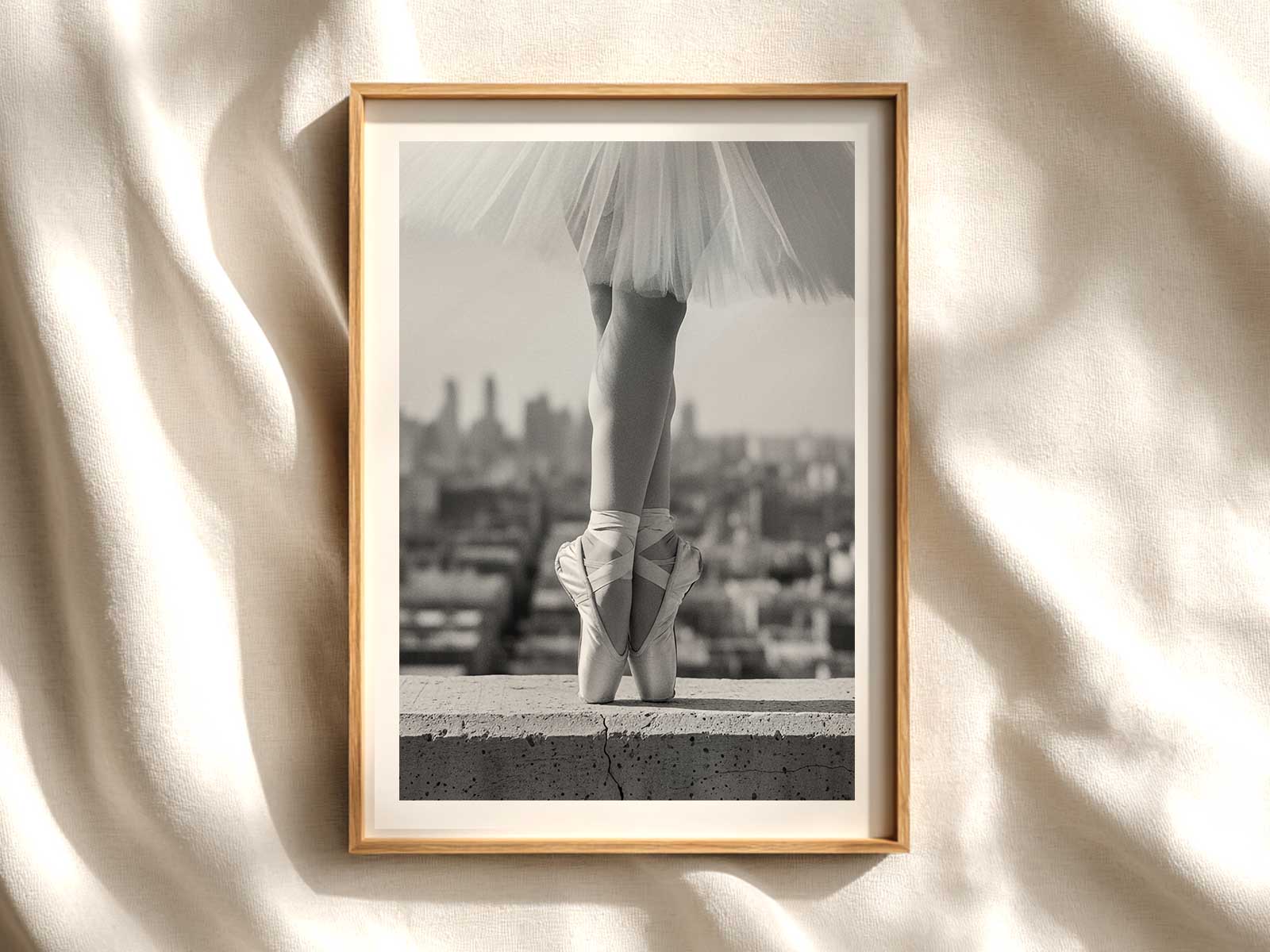 Silhouette of a ballerina centered on a neutral background highlighting poised arms and extended leg
