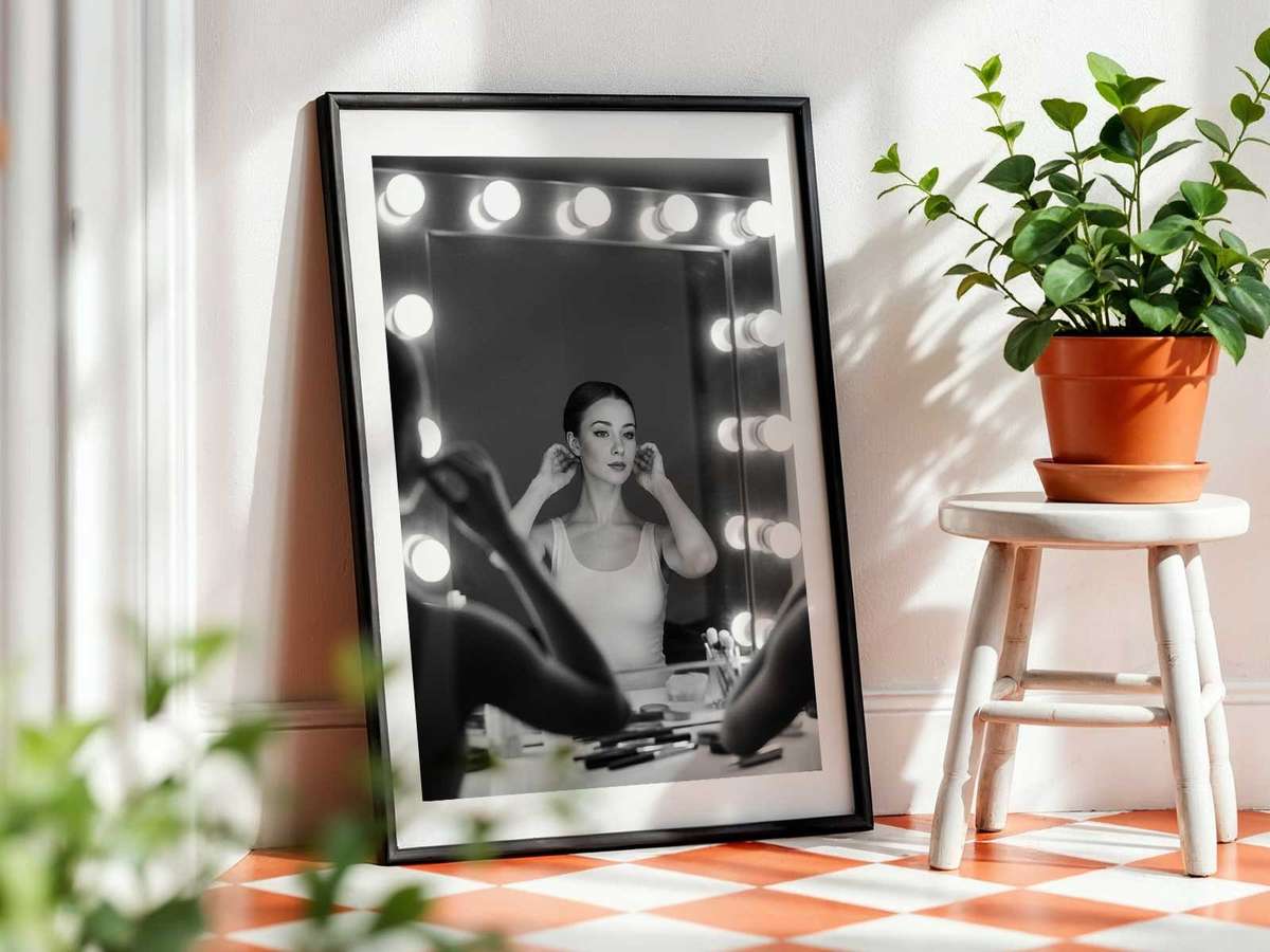 Ballerina adjusting costume in front of a mirror, reflection highlighting costume detail and focused hands