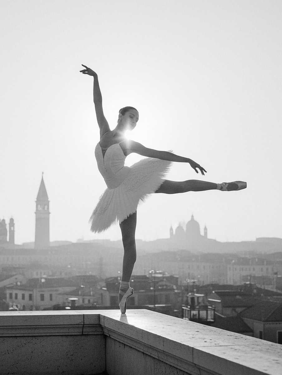 Silhouette of a ballerina mid-pirouette against the Grand Canal at golden hour with vaporetto in distance