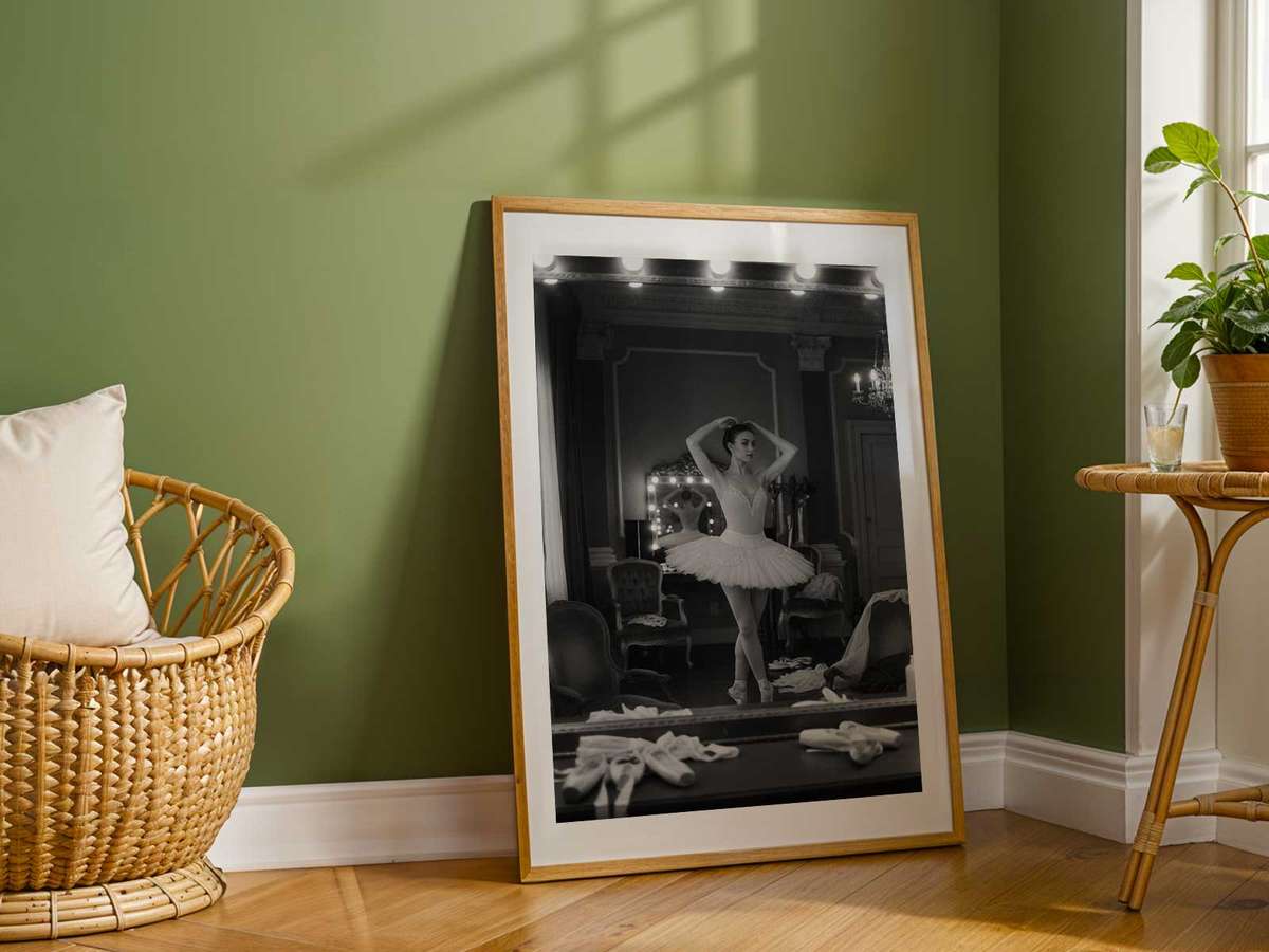 Close portrait of a ballerina gazing into a mirror, reflection revealing a second, softer expression