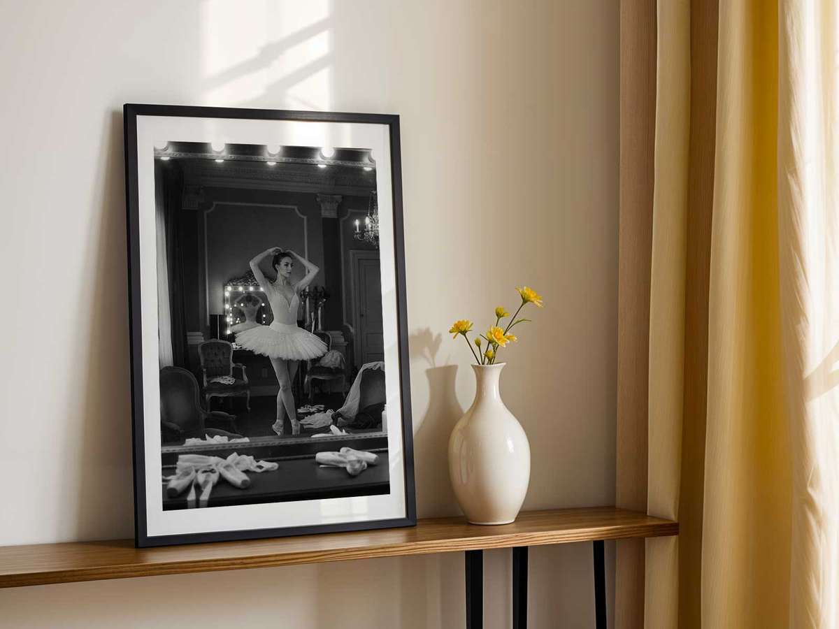 Studio composition where a mirror frames the dancer and her reflection, creating layered planes and compositional depth