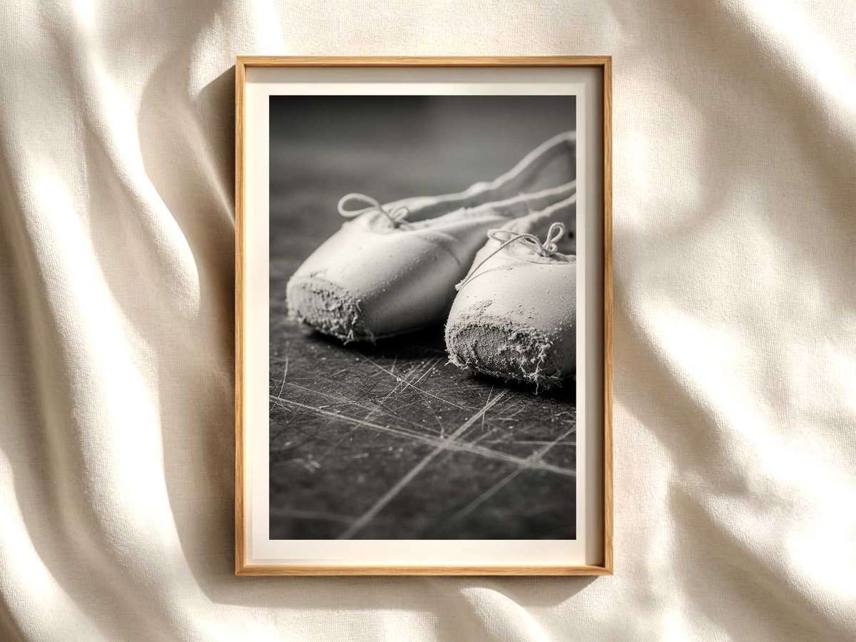 Close-up silhouette of a ballerina's pointe foot showing the shape and tension of the shoe
