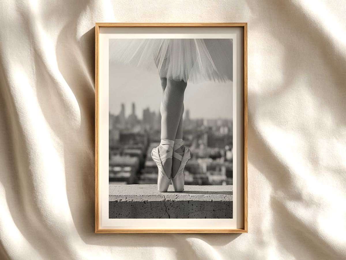 Silhouette of a ballerina centered on a neutral background highlighting poised arms and extended leg