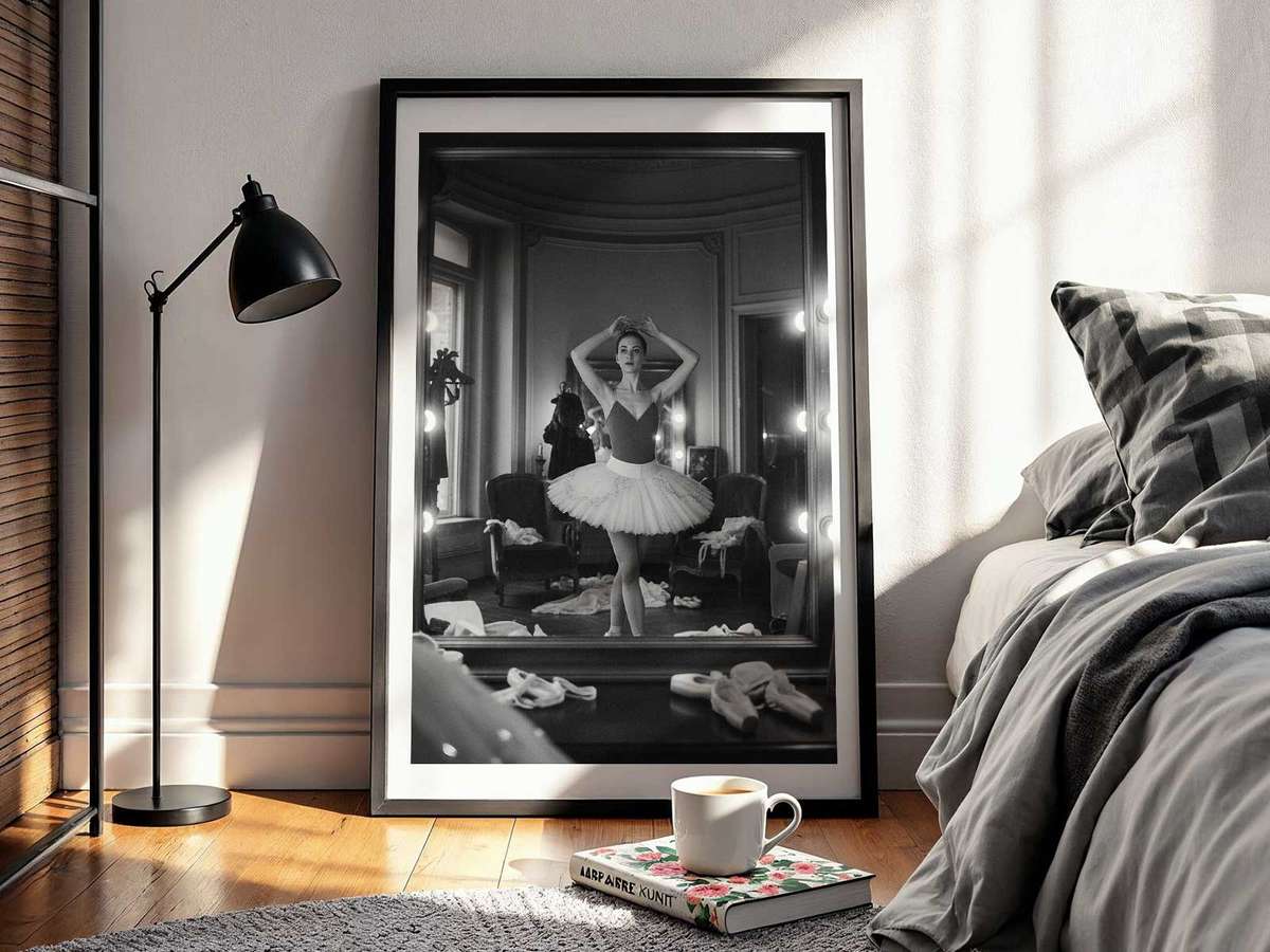 Ballet gesture illuminated by studio light, mirror doubling the delicate curve of the body