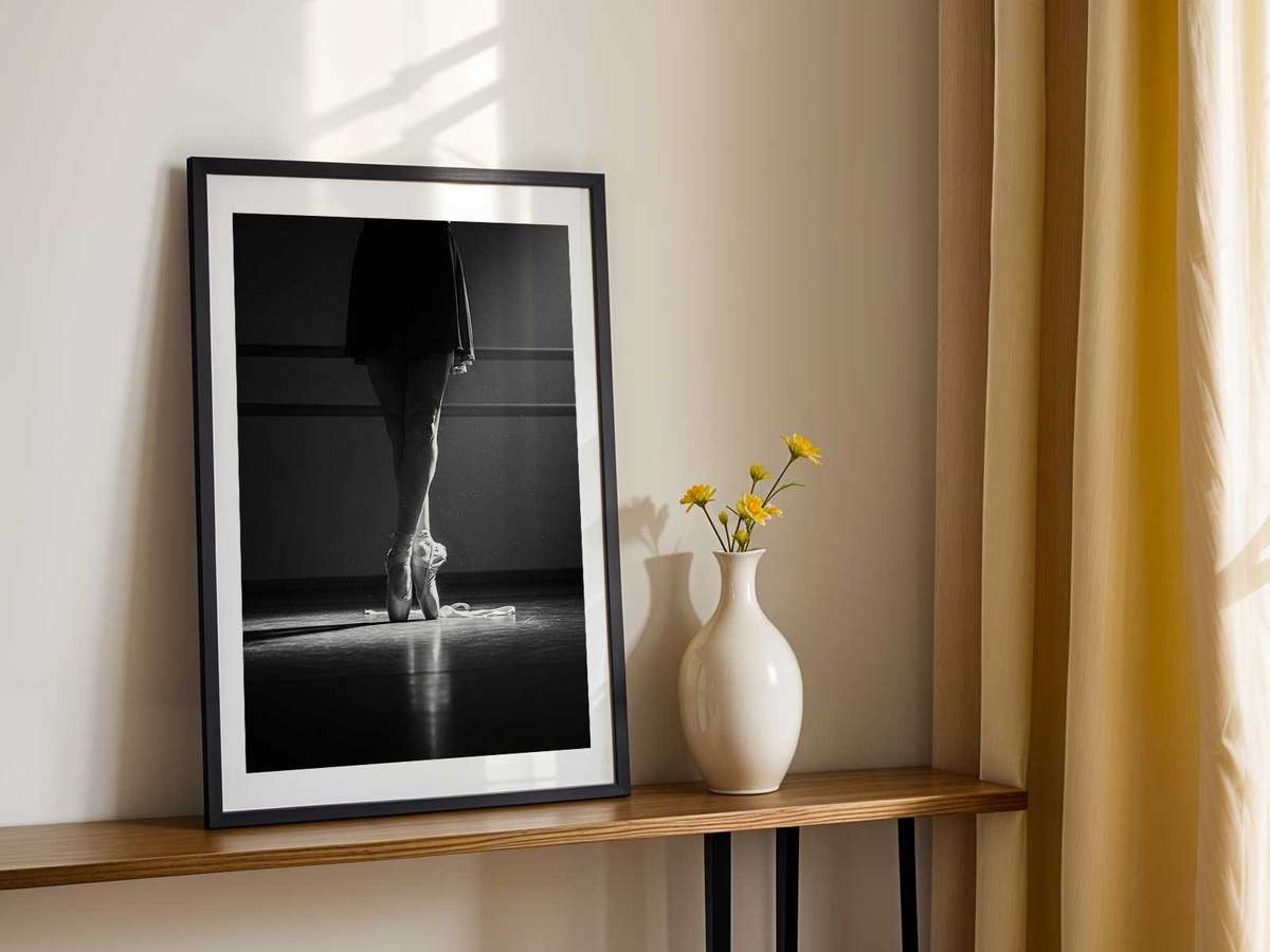 Ballerina reflected in a studio mirror as she practices a pose, the double image emphasizing concentration and…