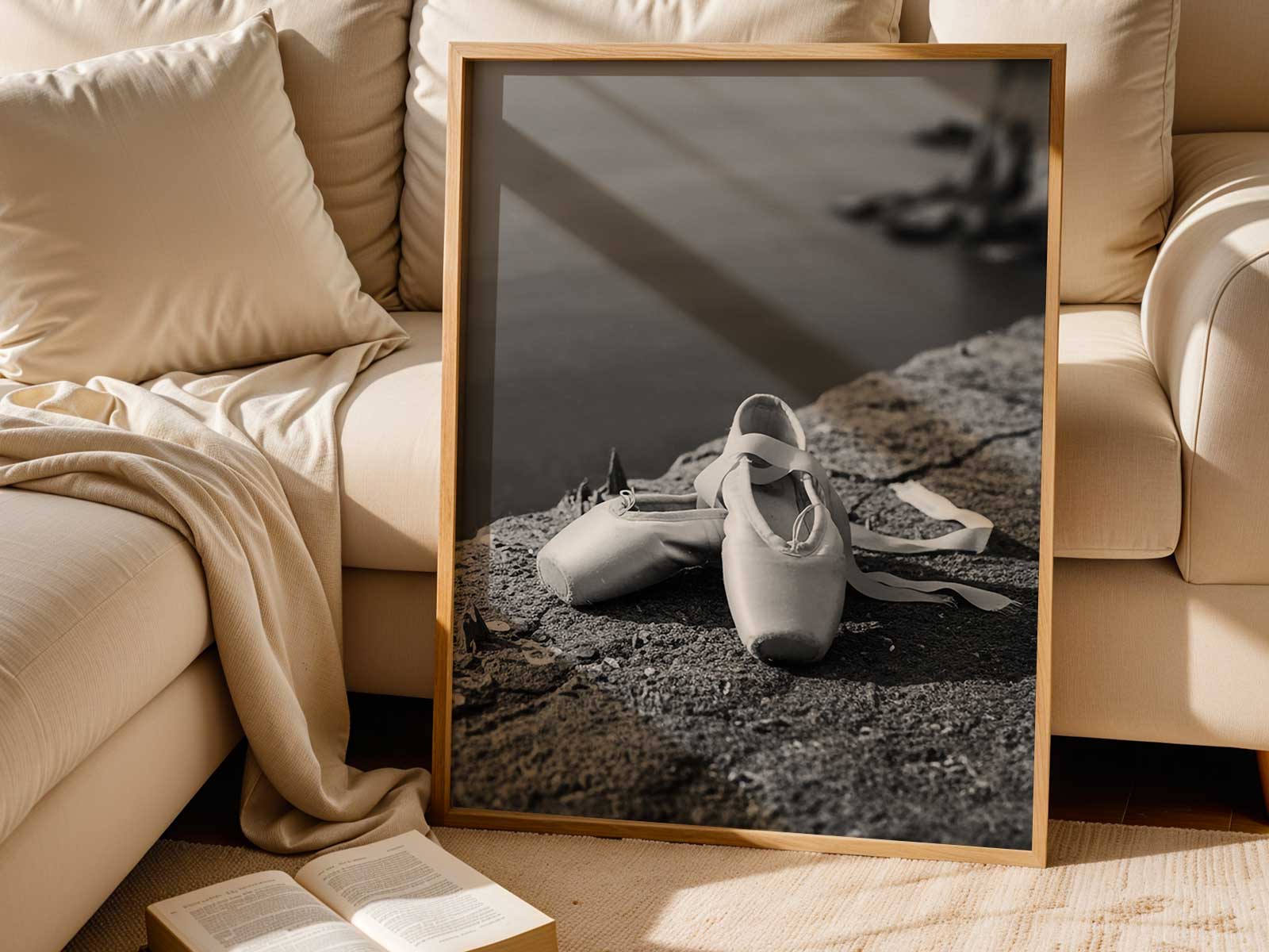 Three-quarter view of a black ballerina seated, printed with grain reminiscent of vintage negatives