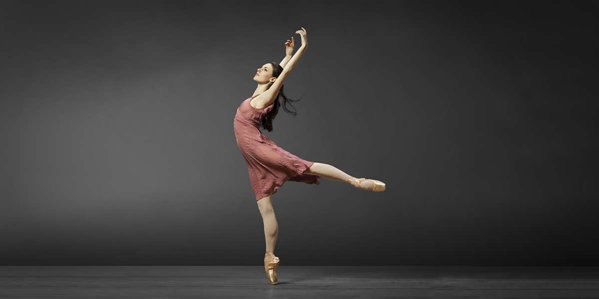 Tiler Peck in a sharp, poised pose at the start of a neoclassical variation, arms crisp and eyes focused